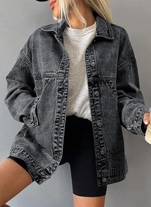 Detail of dark grey oversized denim jacket featuring drop shoulders and snowflake wash finish