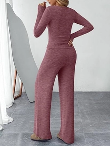 Detail view of the dark red knitted two-piece set featuring long-sleeved top and wide-leg pants