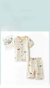 Close-up of soft cotton kids pajamas featuring colorful polka dots and cute dachshund print