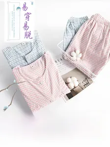 Macro detail of soft cotton flannel nursing pajamas set with pink and blue checkered patterns