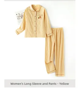 Detail of yellow cotton pajama top with bear embroidery and contrast trim on pocket