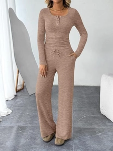 Detail of a brown ribbed long sleeve henley top and drawstring wide leg lounge pants