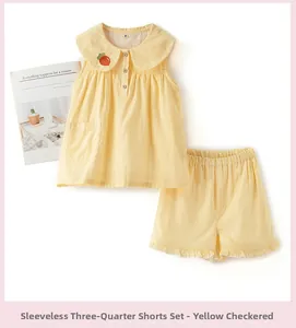 Détail de pyjama d'été en coton à carreaux jaunes pour enfants avec broderie carotte
