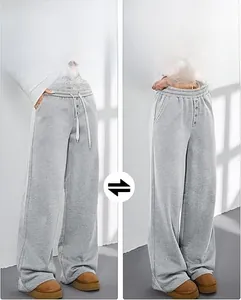 Detail der High-Waist-Jogginghose mit verstellbarem Gürtel und Knopfleiste am Bund