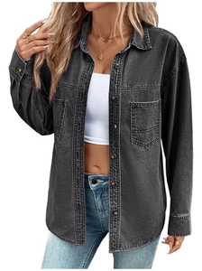 Detailed close-up of washed black denim shirt with wood-texture buttons and dual chest pockets