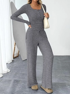 Detail of dark gray knit lounge set showing ribbed texture and drawstring waist pants