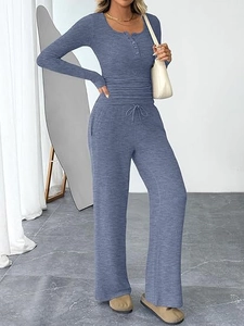 Detail of blue knit set showing button neckline, ribbed texture and drawstring waist