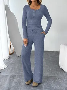 Detail of blue knit loungewear set featuring Henley button neck and waist drawstring