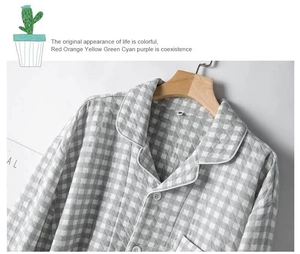 Detail of grey plaid quilted pajama top with notched collar and button closure