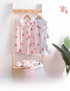 Close-up of quilted three-layer cotton pajamas with sweet peach prints and lace collars