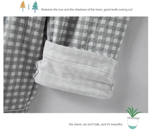 Detail of grey plaid quilted pajama sleeve with thick warm fleece lining and diamond stitching