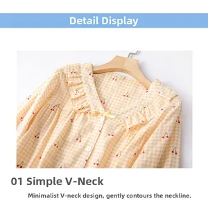 Detail of V-neck cotton pajama top with cherry print, yellow plaid, and small bow decoration