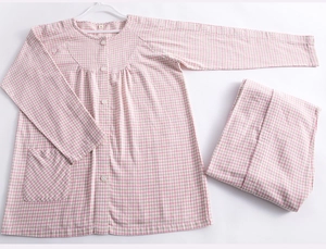Close-up of pink gingham cotton patient care suit with functional buttons and front pocket