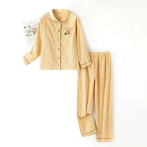 Pale yellow cotton pajama set with vertical stripes, bear embroidery and brown piping edges