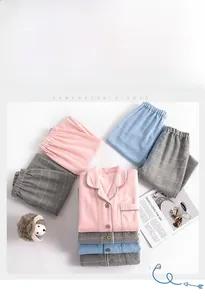 Detailed flat lay of plaid cotton flannel pajamas showing soft texture and button closures