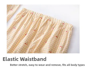 Elastic waistband detail of yellow gingham cotton pajamas with cute cherry print patterns