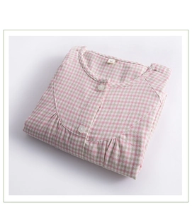 Close-up of pink and beige plaid cotton pajama top with M size label and buttons