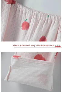 Detail of pink quilted thermal pants with apple print and thick warm fleece lining