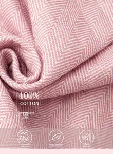 Detail of three-layer 100% cotton quilted fabric with pink herringbone embroidery pattern