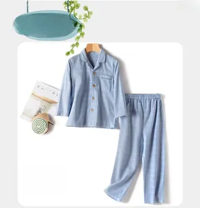 Detailed view of blue plaid cotton pajamas for boys featuring a classic button-down design