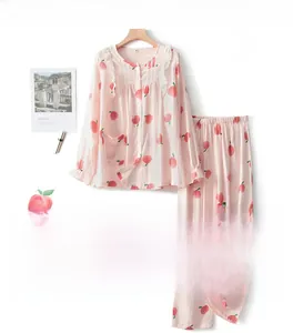 Pink cotton pajama set with peach print and white lace trim details on the neckline