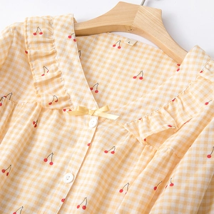 Women's cotton pajamas in yellow gingham with red cherry prints and V-neck ruffle detail