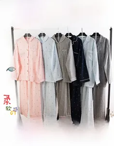 Close-up of double-layer cotton gauze pajama fabric with delicate fish print pattern