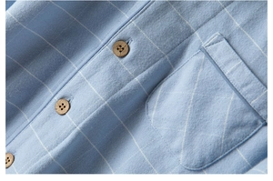 Close-up of soft brushed cotton fabric with blue grid pattern and wooden buttons