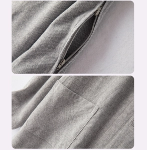 Detail showing high-density stitching, invisible zippers, and gray micro-texture fabric