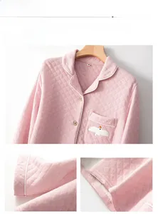 Detail of pink quilted pajama top with white bird embroidery and wood buttons