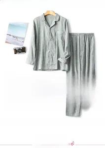 Close-up of gray cotton pajama set featuring white leaf print and wood-textured buttons