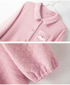 Detail of pink herringbone quilted pajama top with bird embroidery and elastic cuffs