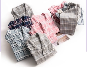 Detail view of plaid cotton pajamas with contrast piping and soft brushed texture