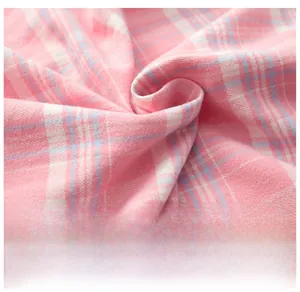 Close-up of soft pink and white plaid brushed cotton fabric for pajamas set