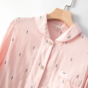 Breathable pink cotton pajama top with navy blue fish pattern and wooden buttons