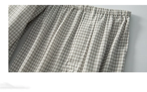 Detail of grey plaid cotton fabric with elastic waistband and precision stitching
