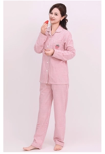Detail of pink plaid cotton pajama set featuring a cute strawberry embroidery and piping