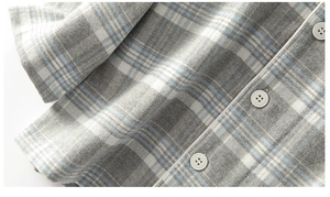 Detail of brushed cotton plaid pajama with white piping and four-hole button closure
