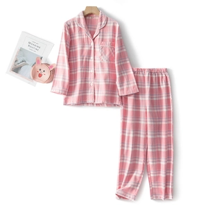 Pink plaid cotton pajama set for kids featuring a long-sleeve button-up top and matching pants