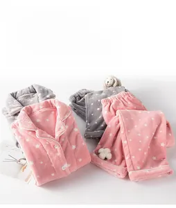 Detail of pink and gray coral fleece pajama sets with white star patterns and button-up collars