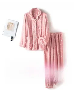 Detail of pink coral fleece pajama set featuring white star prints and soft texture