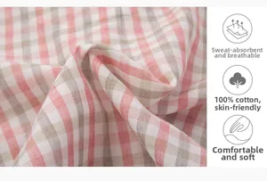 Detailed macro shot of soft pink and khaki plaid pattern 100% pure cotton fabric