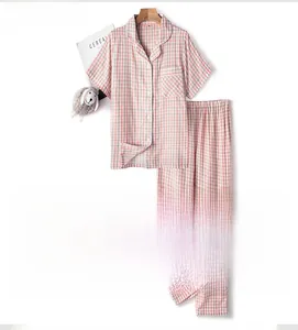 Detail of pink plaid cotton pajama set with short sleeves, lapel, and buttoned closure