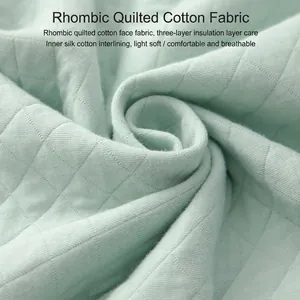 Mint green triple-layer quilted pajama fabric with warm diamond stitching pattern