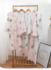 Detail view of cotton flamingo print kimono pajamas hanging on a wooden rack