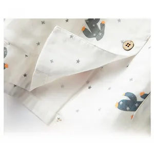 Detailed view of breathable cotton pajamas with cactus print and wood button