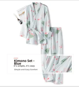 Flat lay of blue cotton flamingo kimono pajamas with magazines and home decor