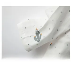 Detail of cotton pajama sleeve cuff with cactus pattern and smooth stitching