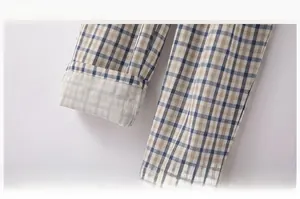 Detail of blue and yellow plaid pajama pants with elastic waistband and folded hem