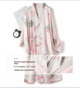 Detail of pink cotton kimono robe with flamingo and tropical palm leaf print